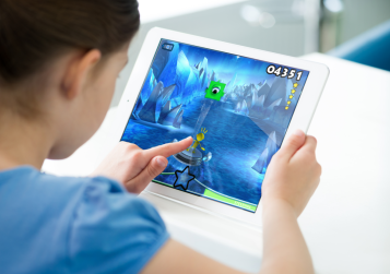 Child playing game on an iPad