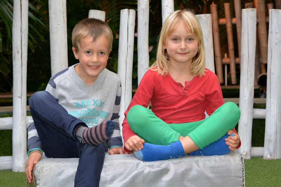Male and female children sitting next to each other
