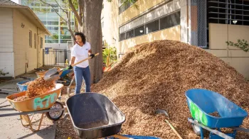 Jessica Arline, Associate Director Community and Government Relations UCSF, helps mulch the landscaping and blocks around UCSF Benioff Children’s Hospital, with a group working to improve the neighborhood as part of Oakland Volunteer Day.