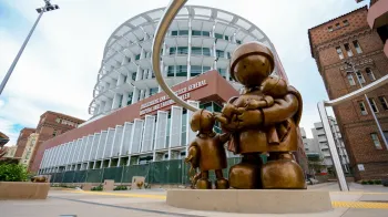 Statue of mother and children in front of hospital