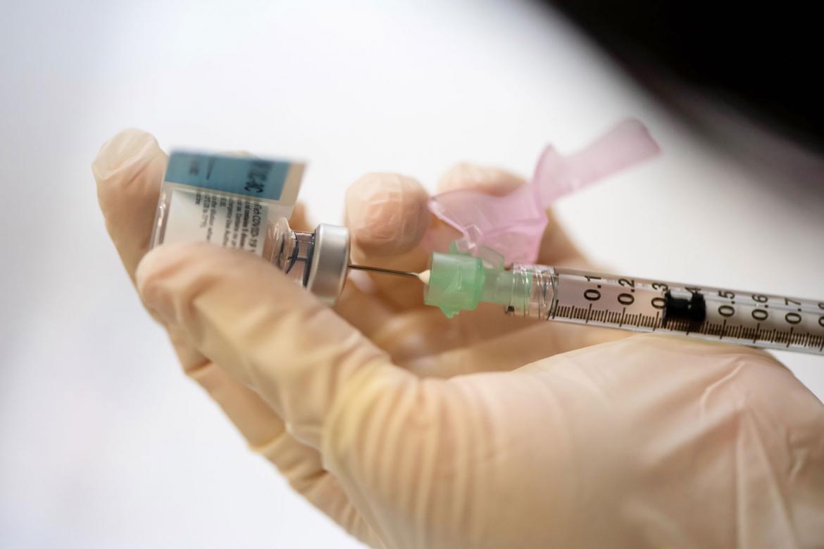 Vaccine being extracted from a vial