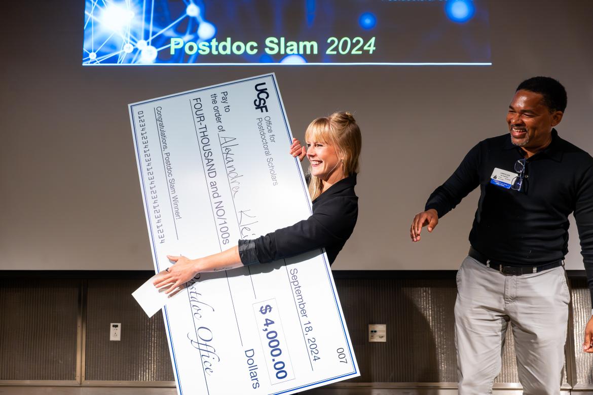 Klein holding a big check