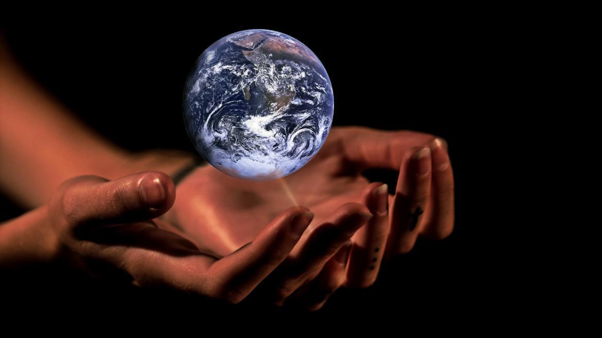 Outstretched hands cradling the planet Earth