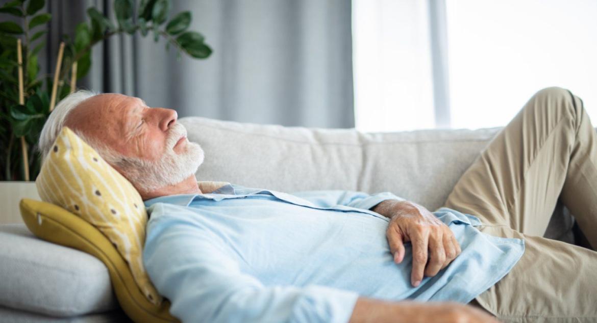 Older person sleeping on a couch