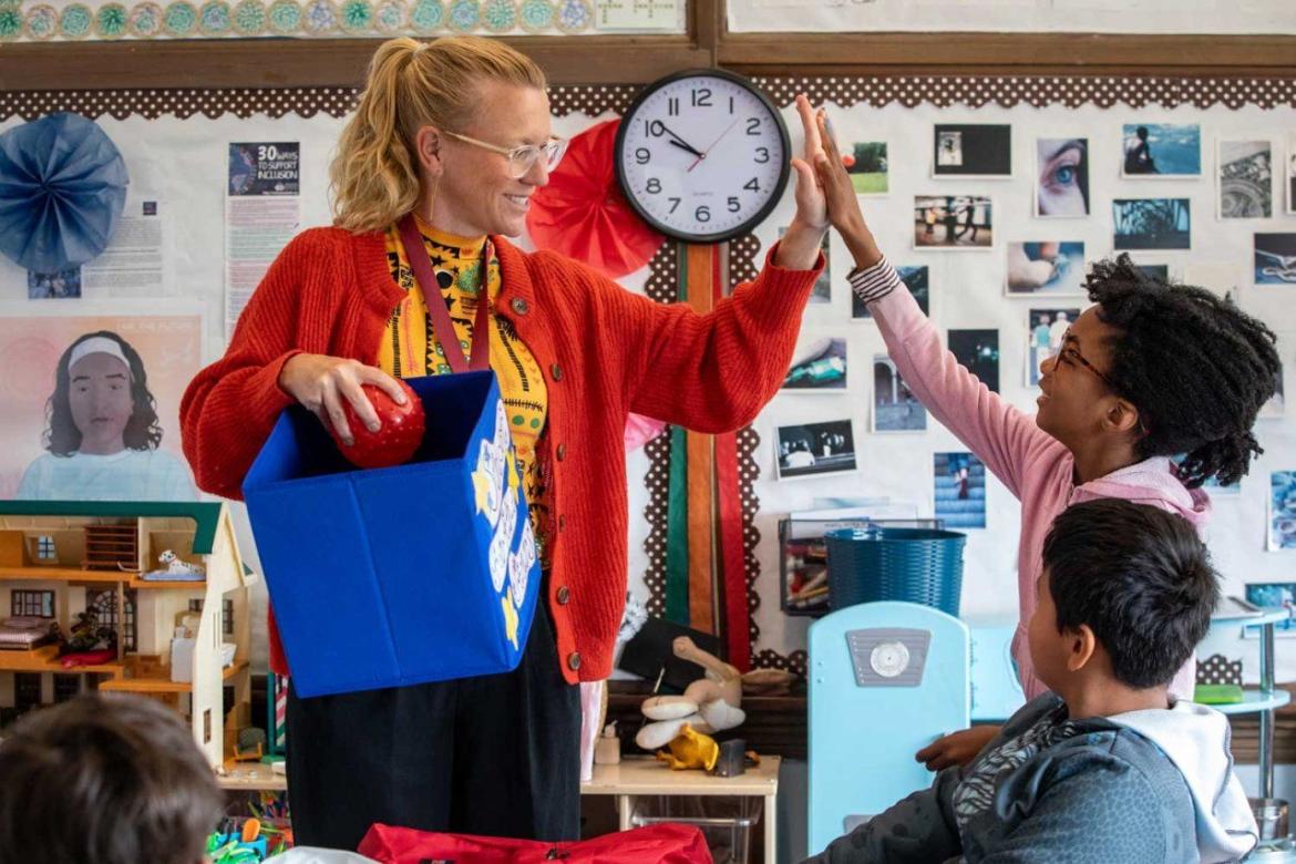 Social worker and student exchange a high five.