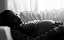 Black and white image of a pregnant women reclining