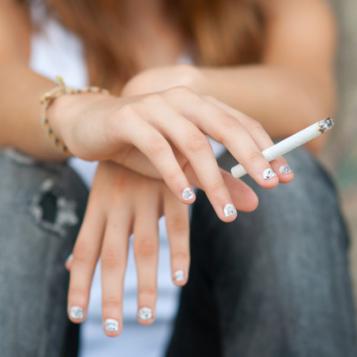 Cigarette in the hand of a teenager