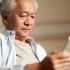 Elderly man reading a tablet