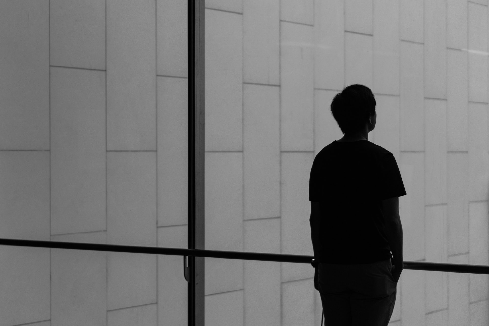 Silhouette of a person standing in front of a window